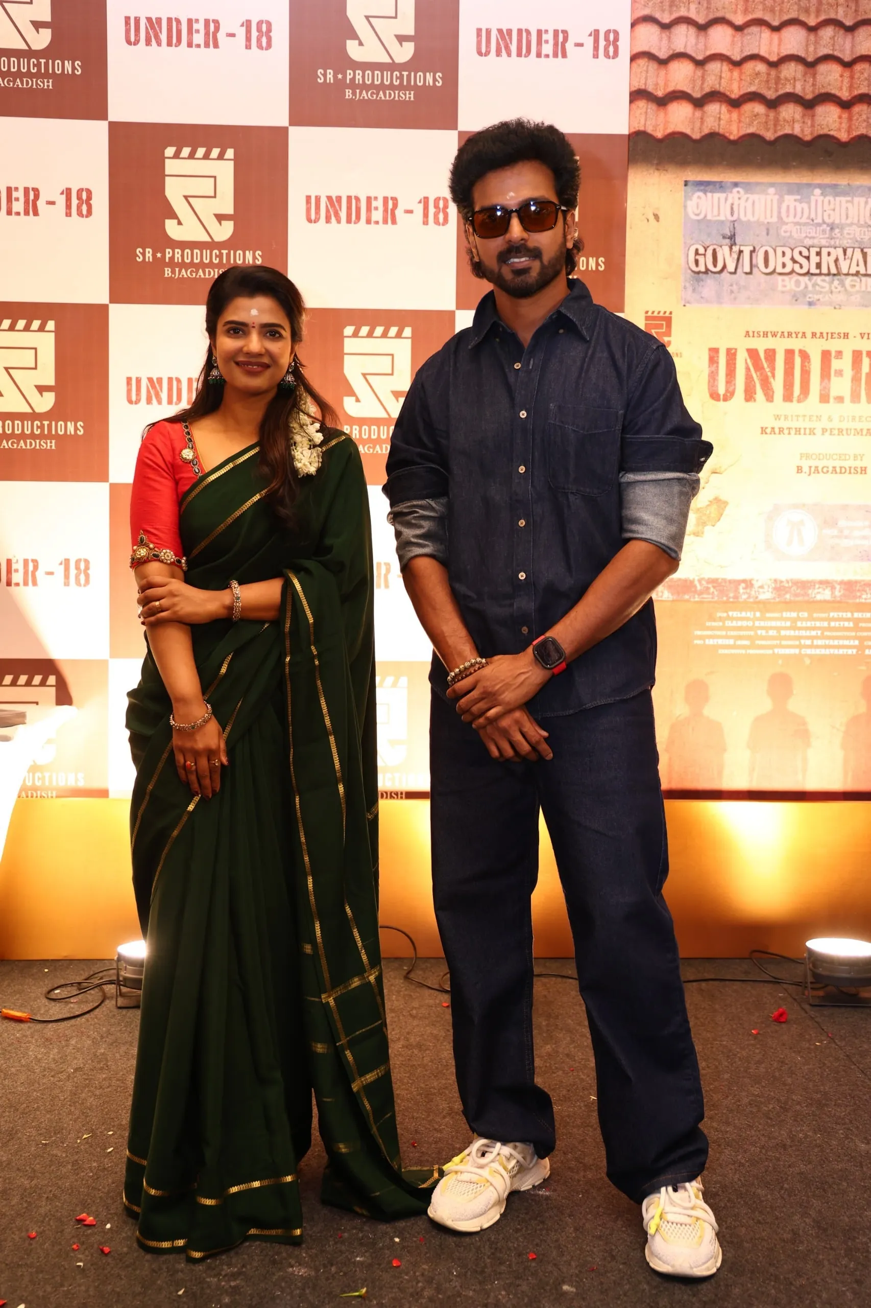 Vikranth and Aishwarya Rajesh at the launch of Under 18, in front of the film's poster