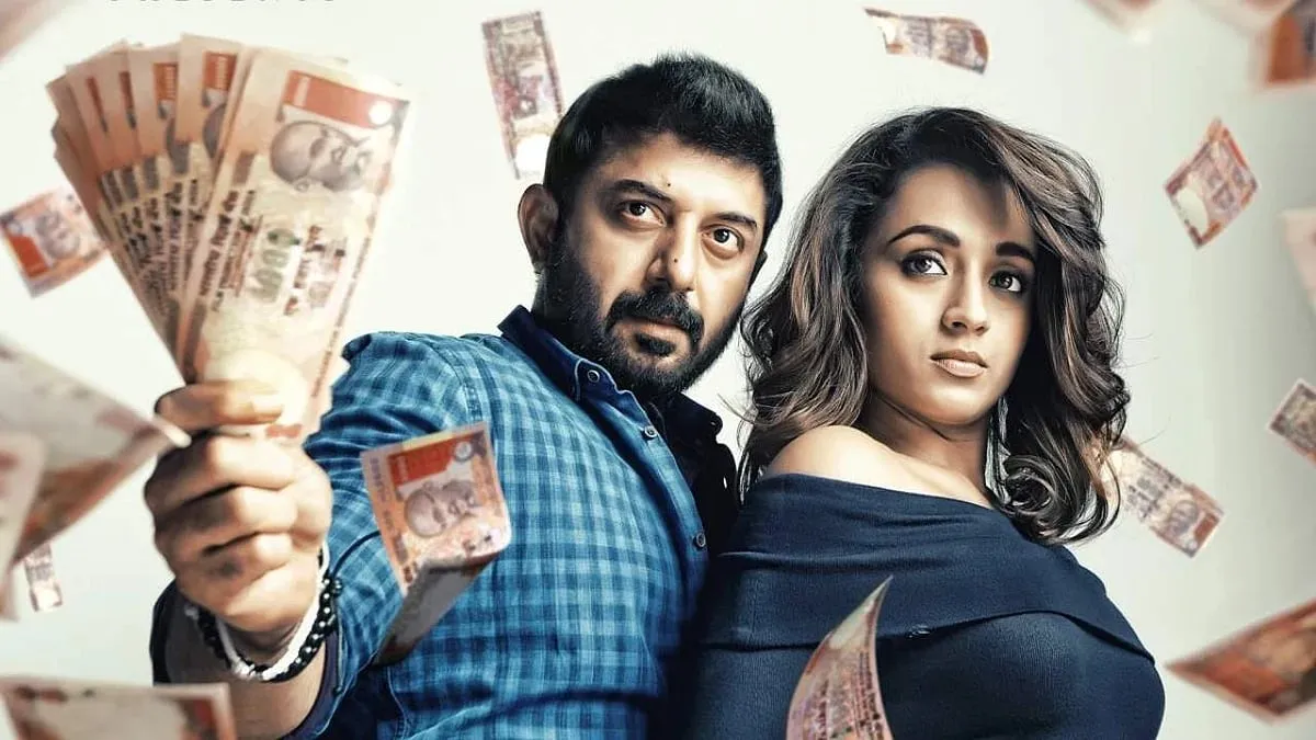 Arvind Swamy holds a fan of thousand-rupee notes beside Trisha as currency rains around them in a Sathuranga Vettai 2 promotional still