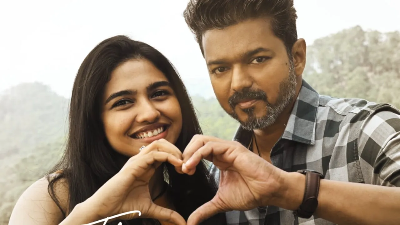 Vijay and Mamitha Baiju making a heart shape with their hands in a still from Jana Nayagan