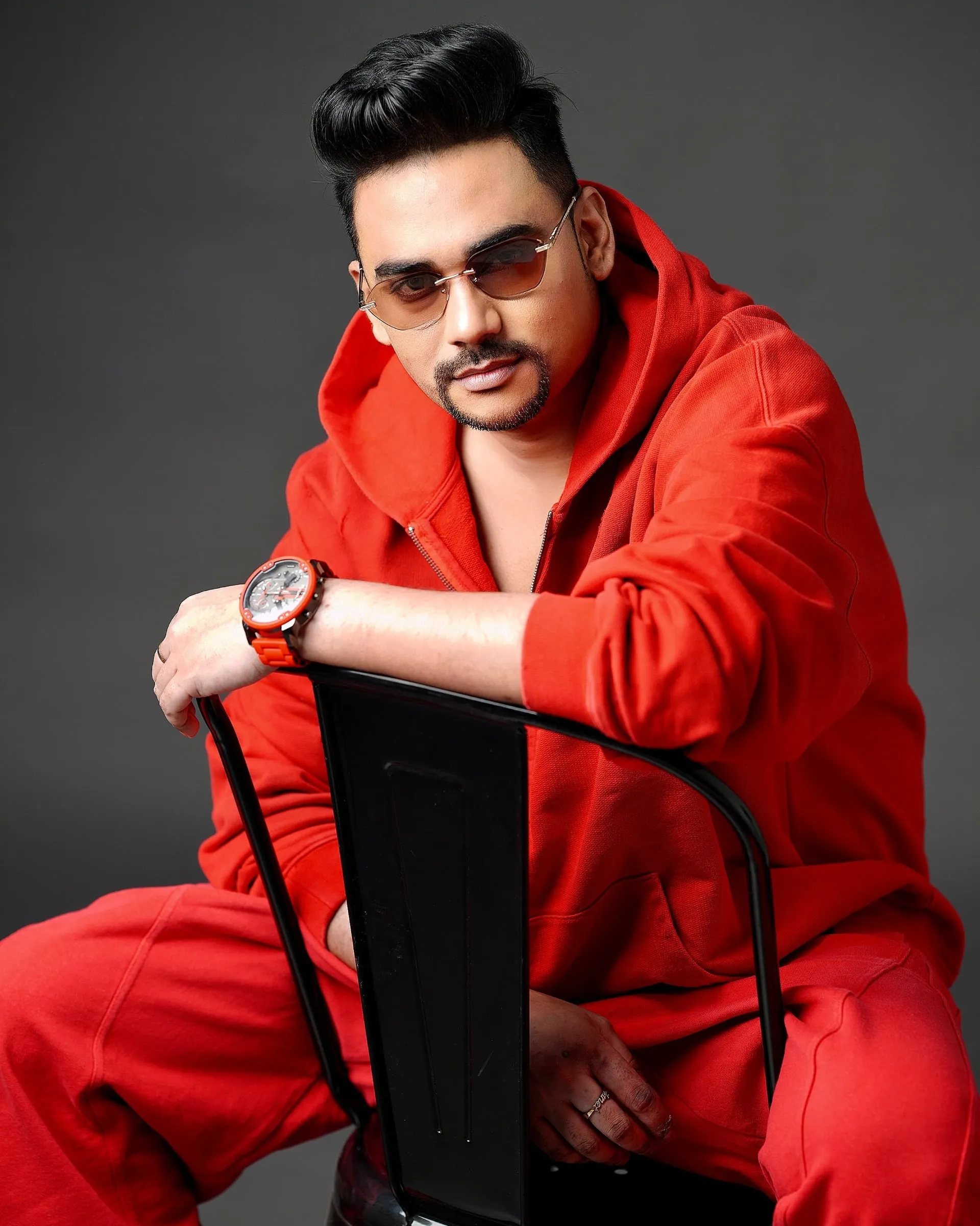 Composer Sam C.S. in a red portrait