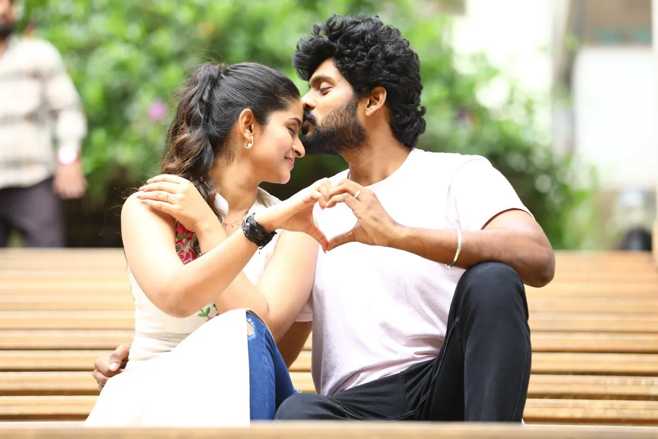 Romantic still from Breakfast Tamil movie with the lead pair on a bench