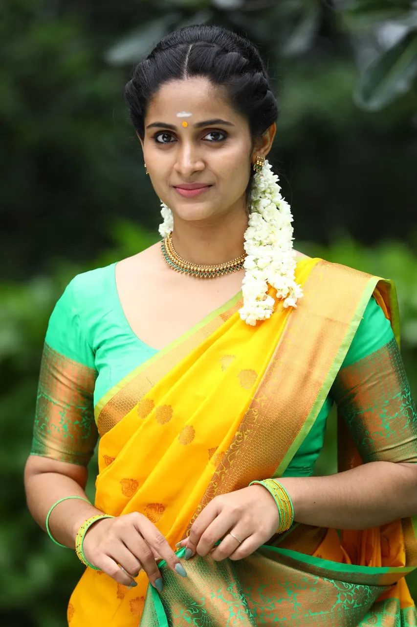 Actress Rosmin in a yellow silk saree with green border and jasmine, in a Breakfast promotional portrait