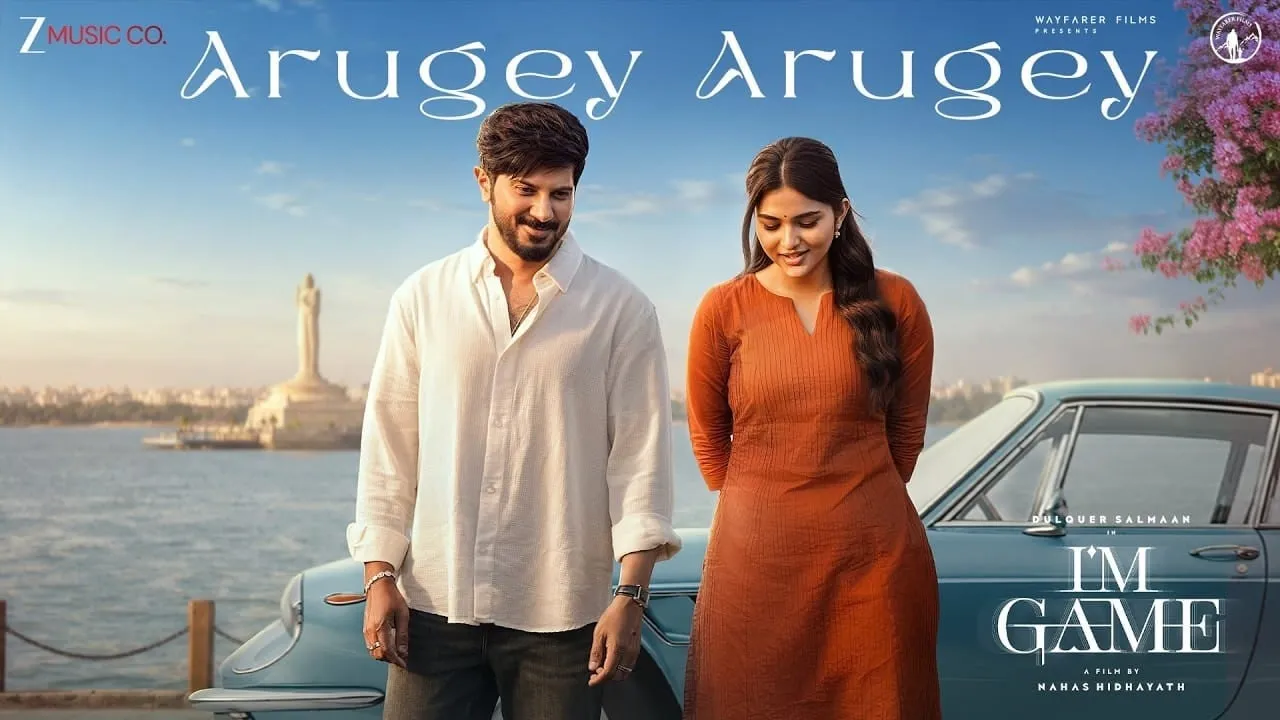 Dulquer Salmaan and Kayadu Lohar beside a vintage car on the Arugey Arugey song poster