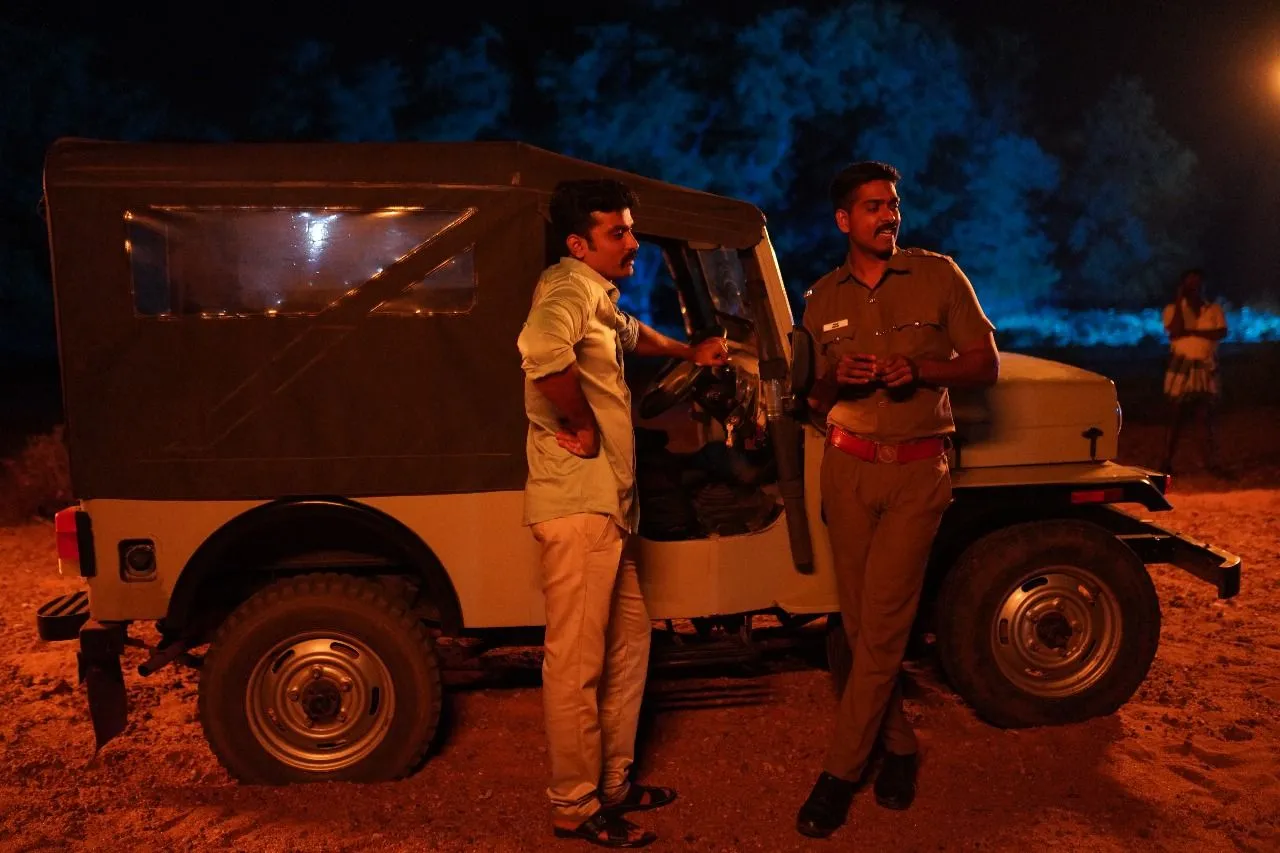 Scene from The Dark Heaven showing two men by a police jeep at night