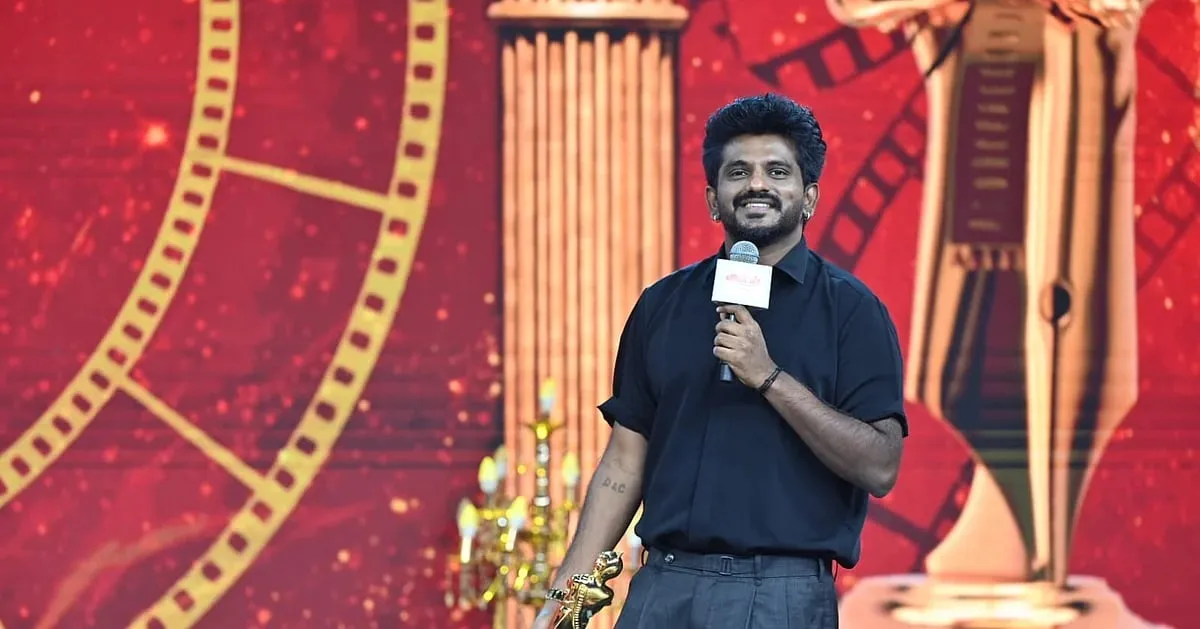 Ashwath Marimuthu on stage with the Best Entertainer trophy at the Ananda Vikatan Cinema Awards