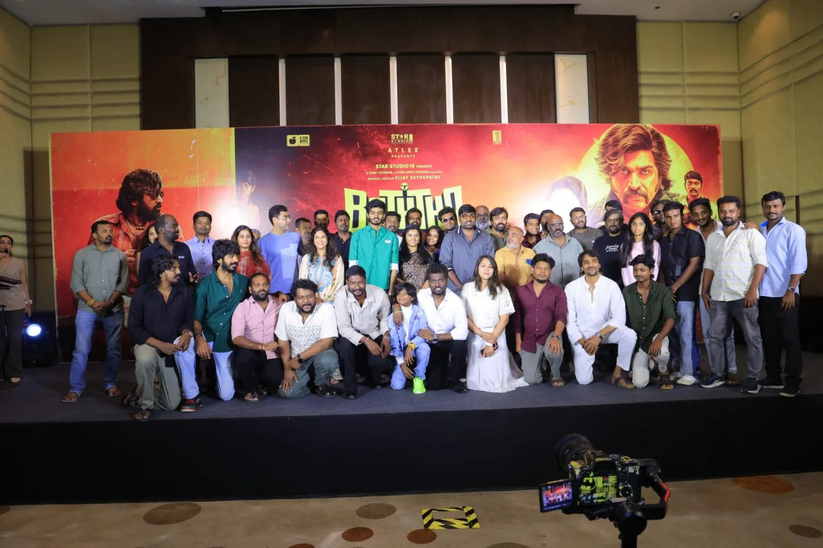 The Baththa cast and crew, including Vijay Sethupathi, Atlee and child actor Sai Prithvi Raj, gather on stage in front of the film's poster