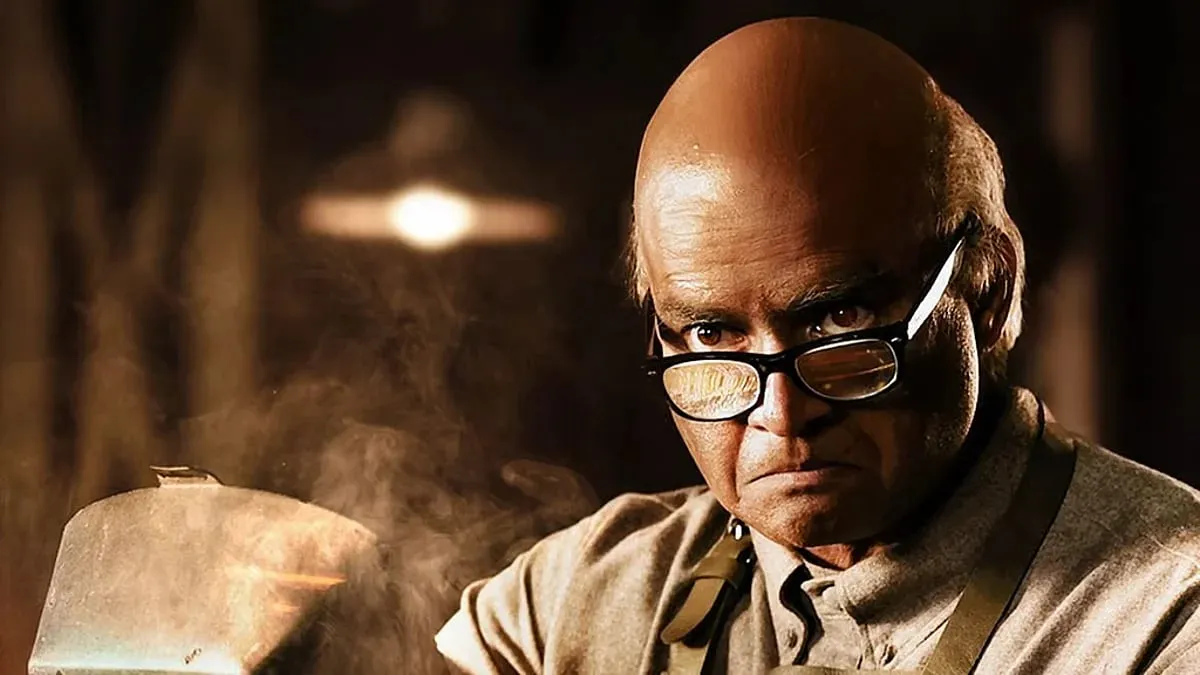 R. Madhavan in old-age prosthetics and glasses as inventor GD Naidu in a workshop, in a still from GDN