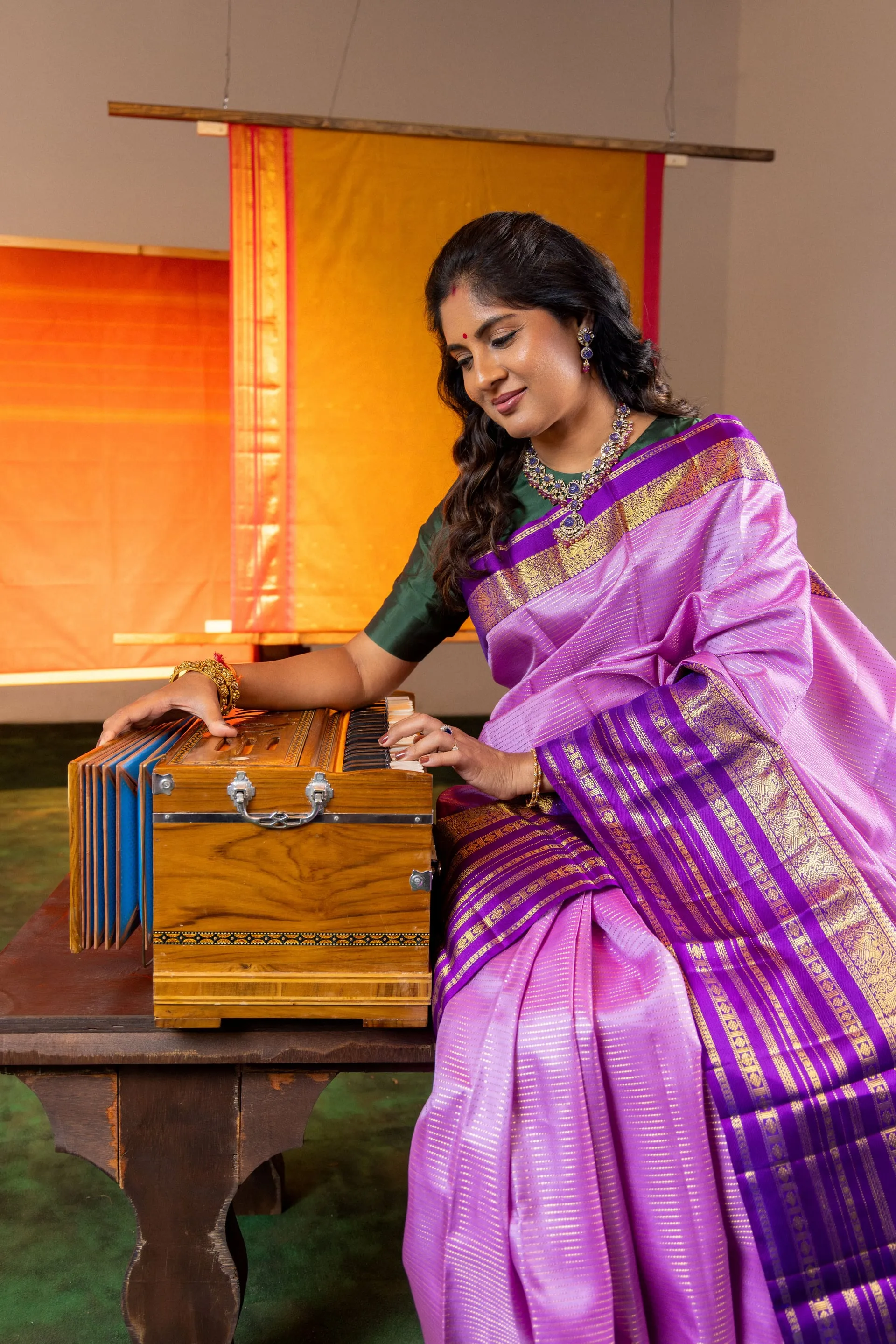 Charulatha at the harmonium, which she trained on classically before moving into playback.