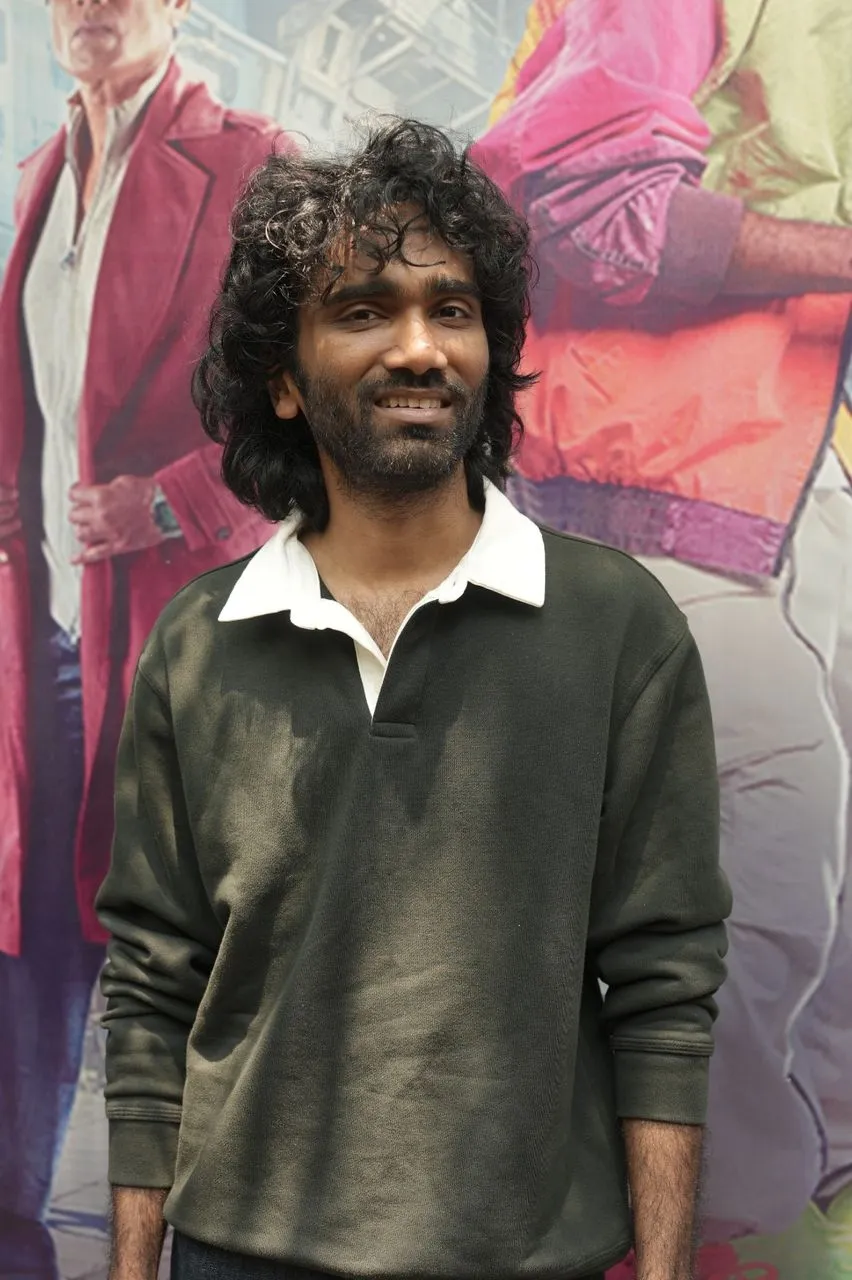 A LIK cast member in front of the film's Chennai event backdrop
