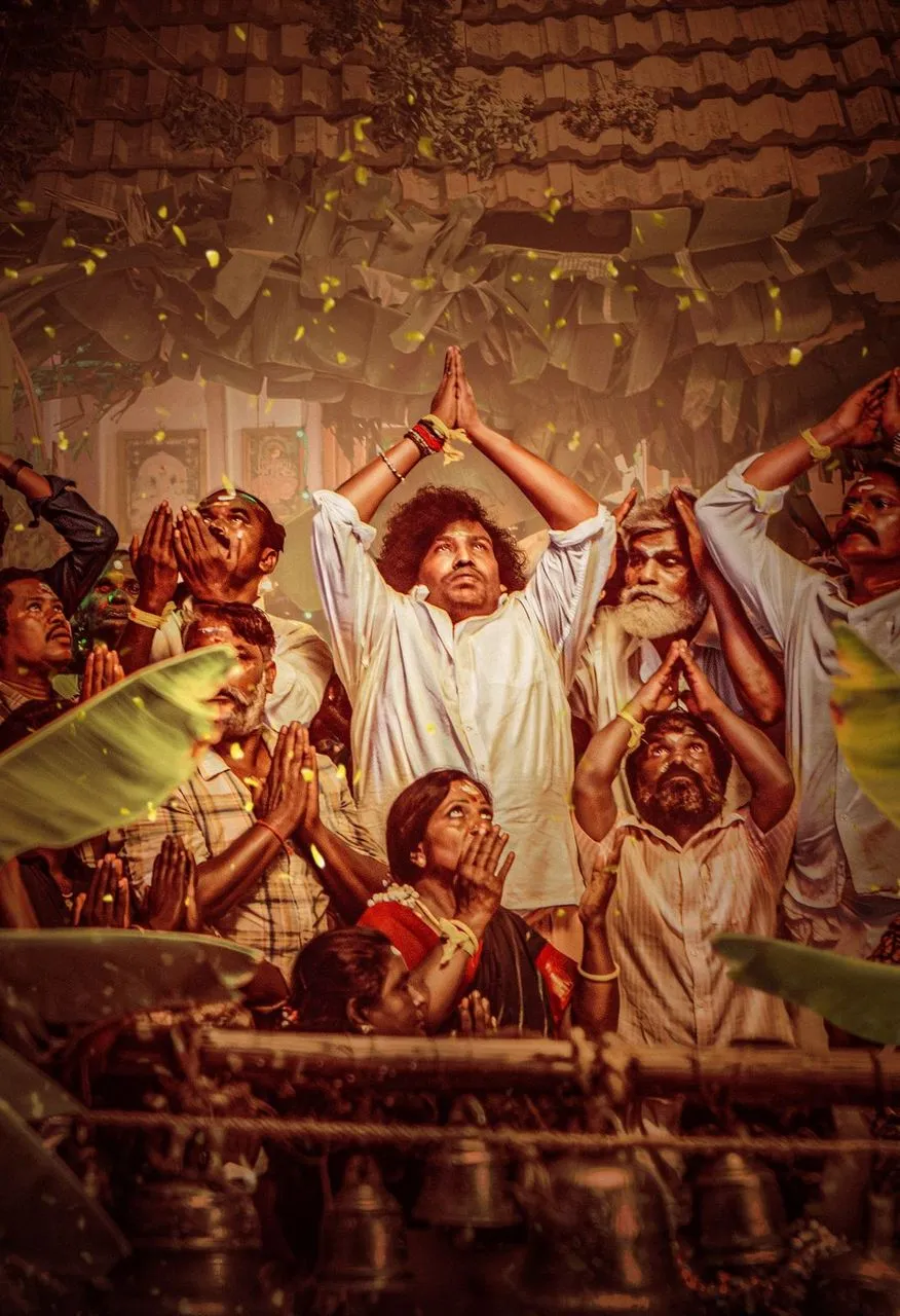 Yogi Babu in Kenatha Kanom standing with folded hands amid villagers
