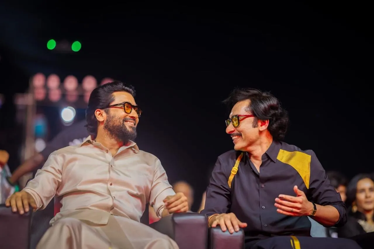 Suriya and director RJ Balaji on the front row at the Karuppu audio launch in Madurai.