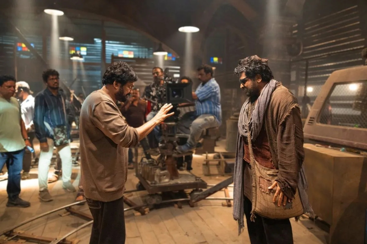 Puri Jagannadh giving direction to Vijay Sethupathi on the Slum Dog set with the camera crew in view