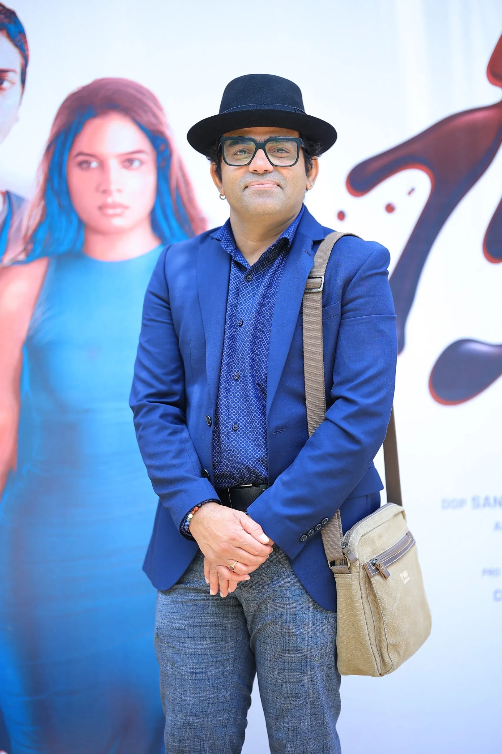 In front of the Niram poster