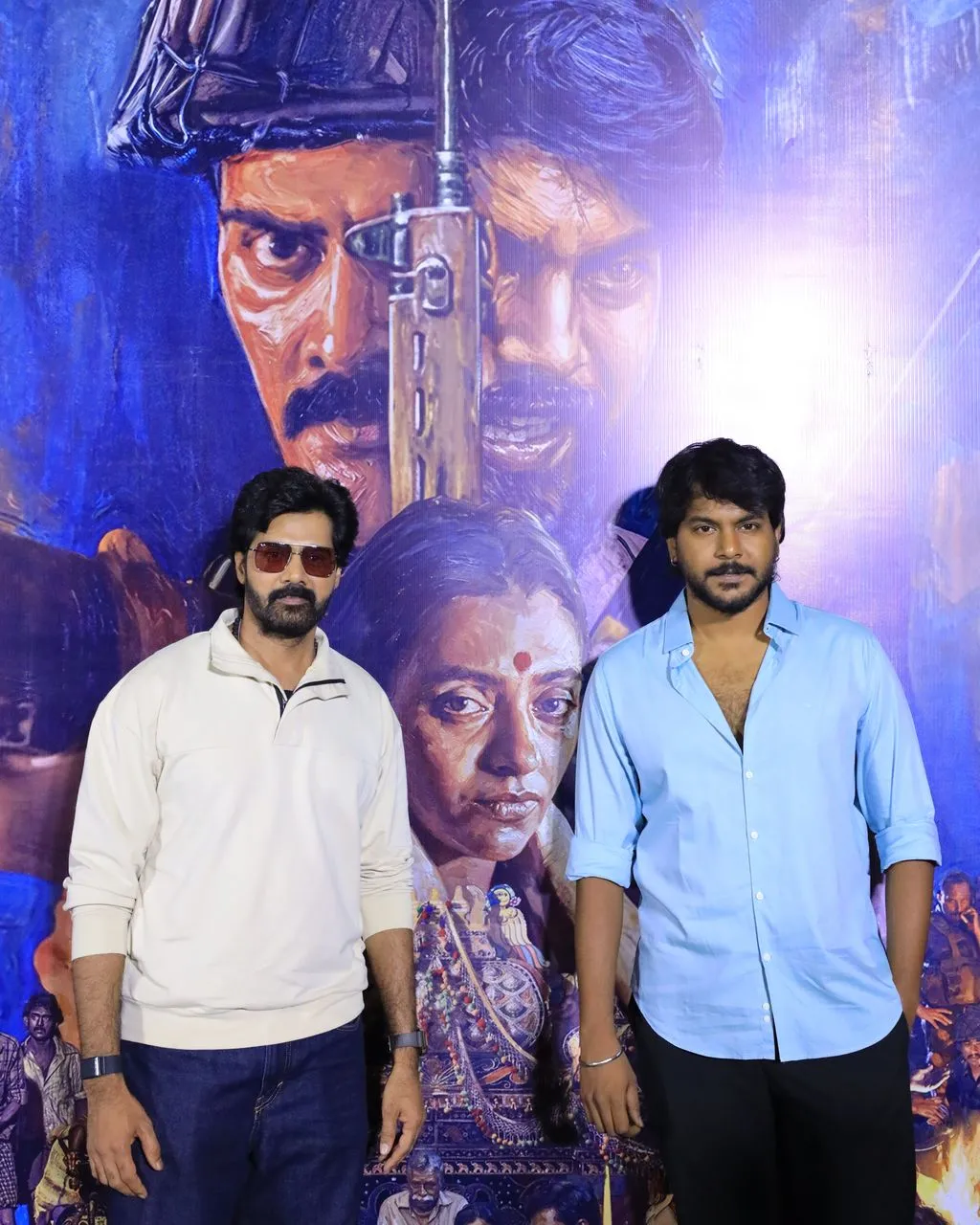 Neelira actors posing with the film's poster