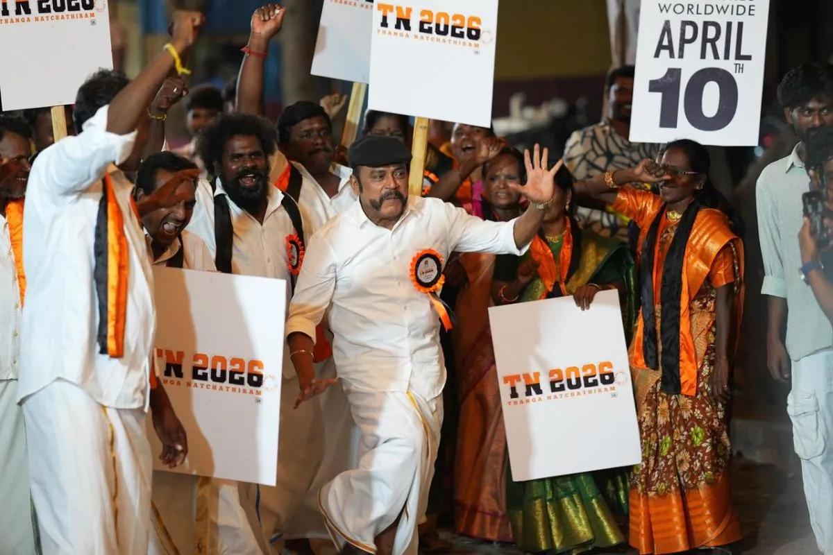 Natty waving to the crowd with TN 2026 placards at the press meet rally