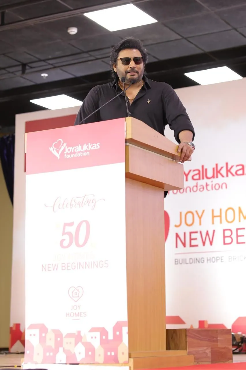 Actor Prashanth speaking at the Joy Homes ceremony podium