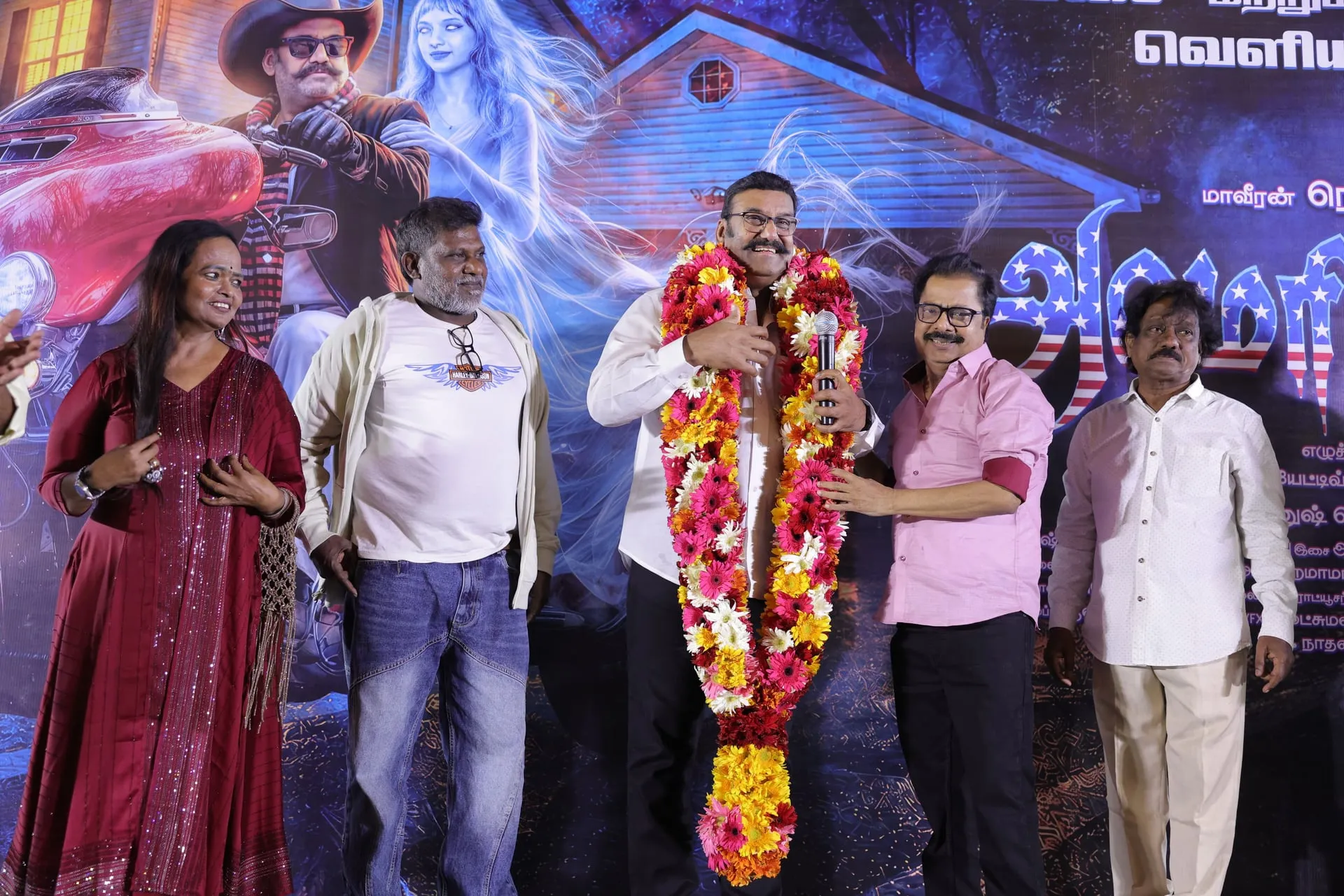 Napoleon is garlanded on stage at the America Aavi launch