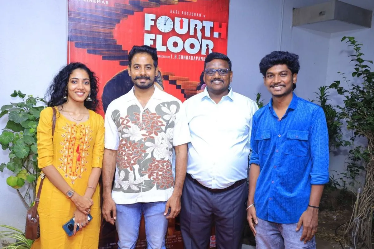 Fourth Floor cast and crew in front of the film poster