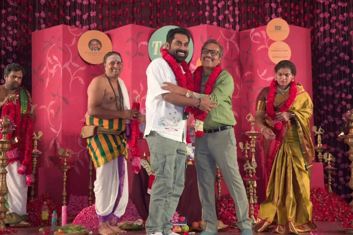 Producer Kannan Ravi garlanded and embraced on stage during the Texla puja