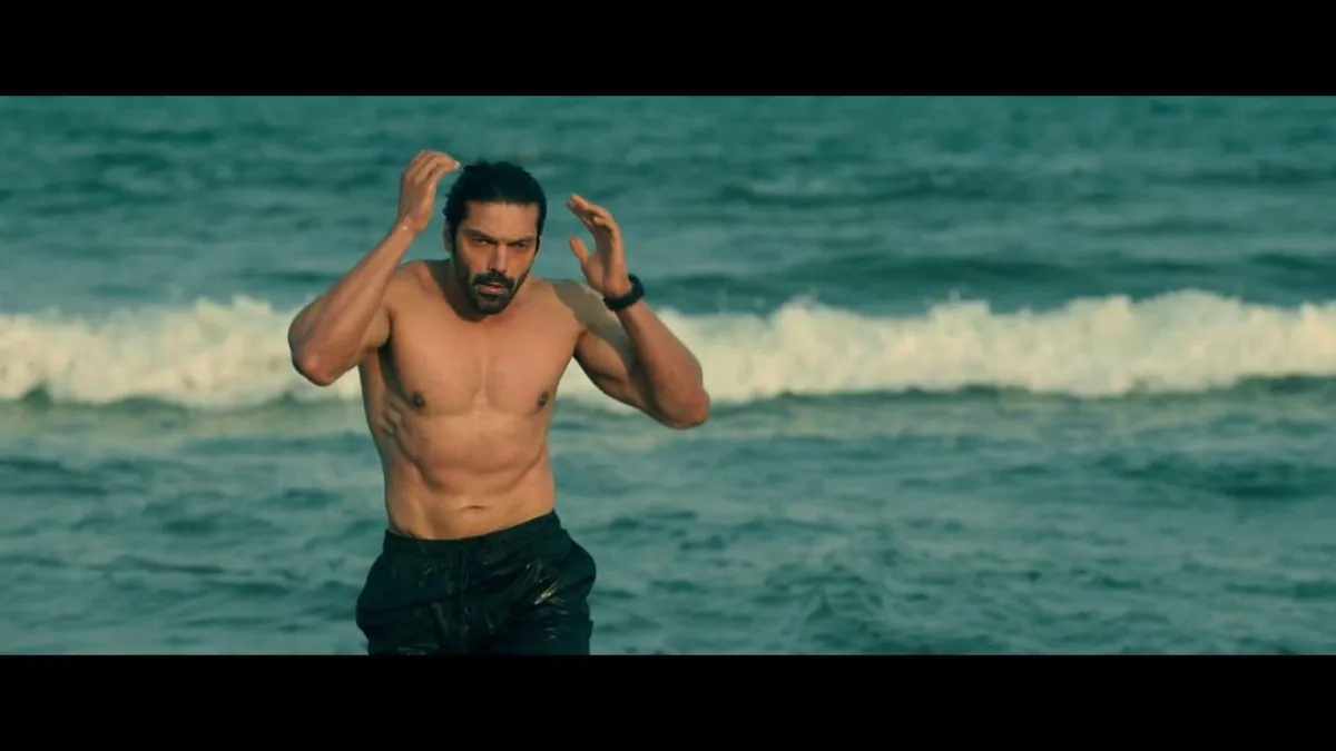 Arya emerging from ocean waves in a scene from Mr X