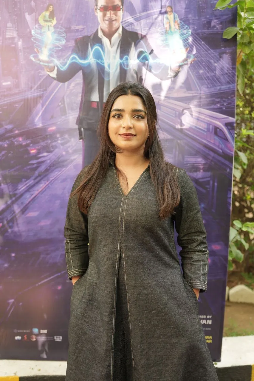 Deepika Venkatachalam at the LIK thank-you meet in front of the film poster